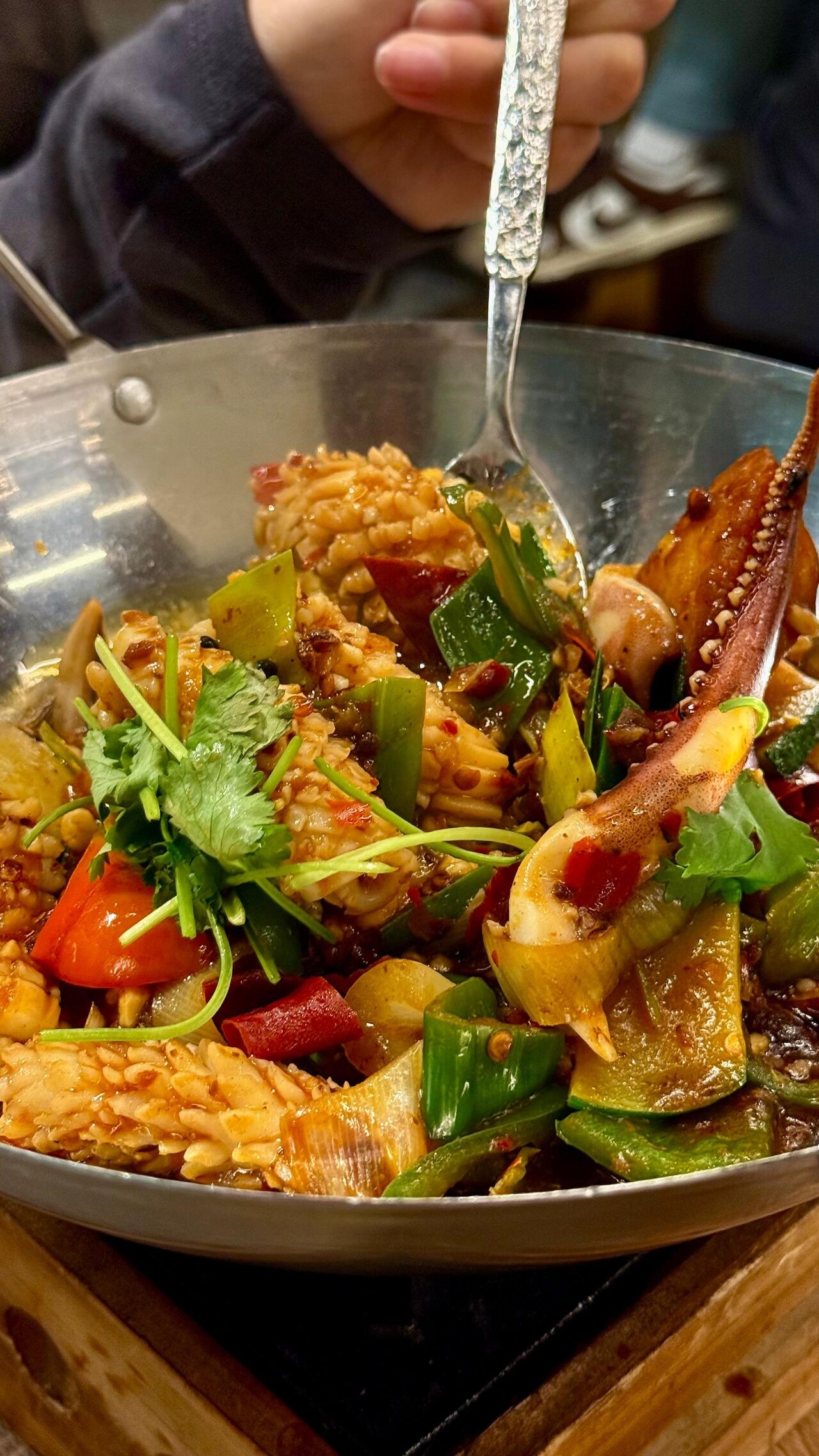 Squid stir-fried with peppers and coriander.